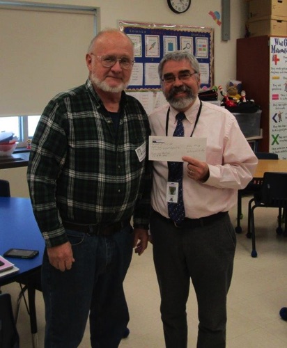 2019 Winner - President Lynn Hunneyman (L) presents a check to Mike Kinnie (R), 5th grade teacher at Alexandria Central School.